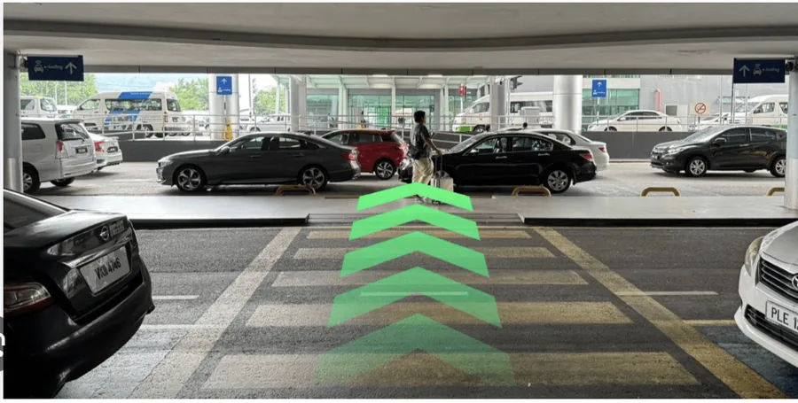 Pedestrian crossing leading from the terminal kerbside towards the multilevel car park.
